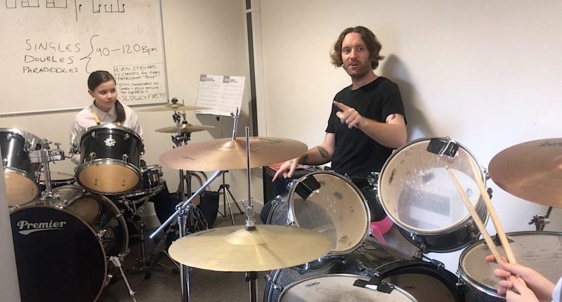 greenie teaching a group class drums